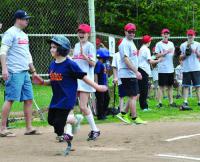 Jane Richard, 8, crosses the plate on Xavier Bell’s hit, posting a run for the Savin Hill Astros. Photo by Bill Forry